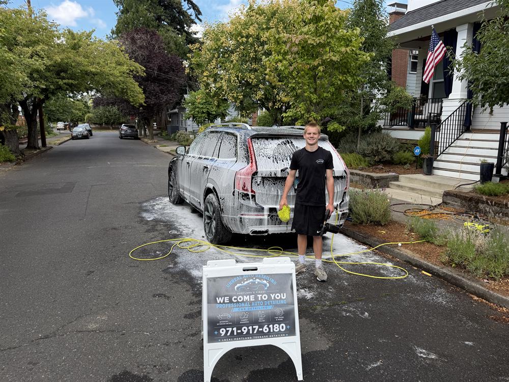 Bronx set up on a job in the Grant Park neighborhood with the Unreal Auto Detailing sign out front