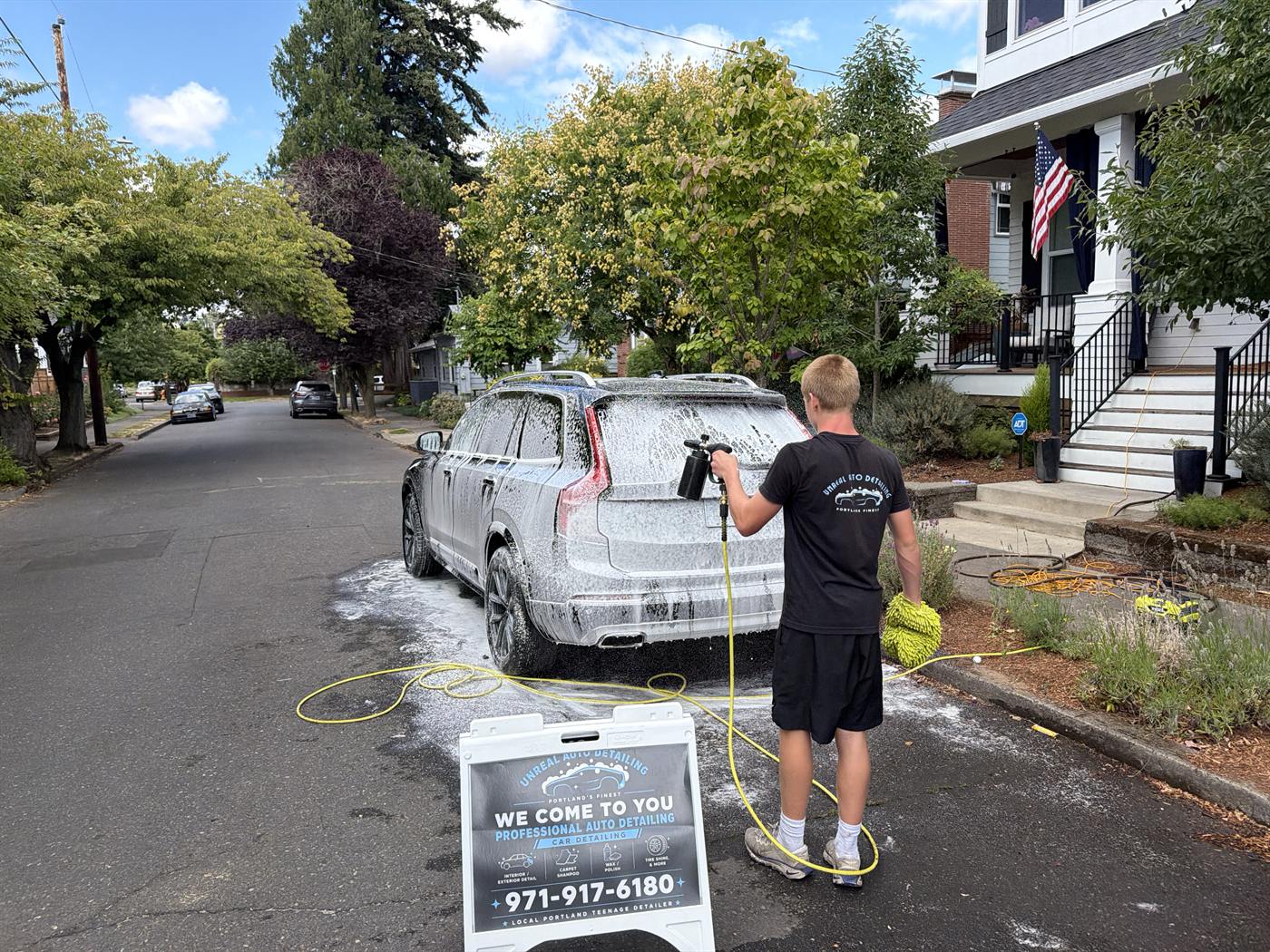 Foam cannon covering an SUV before the hand wash