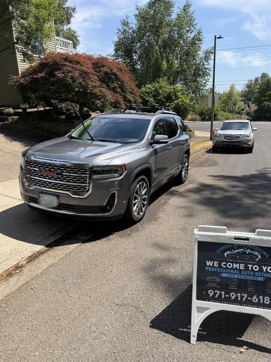 GMC finished beside the detailing sign