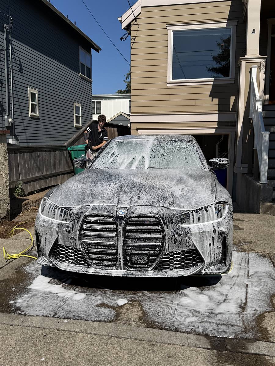 BMW M3 covered in foam mid-wash