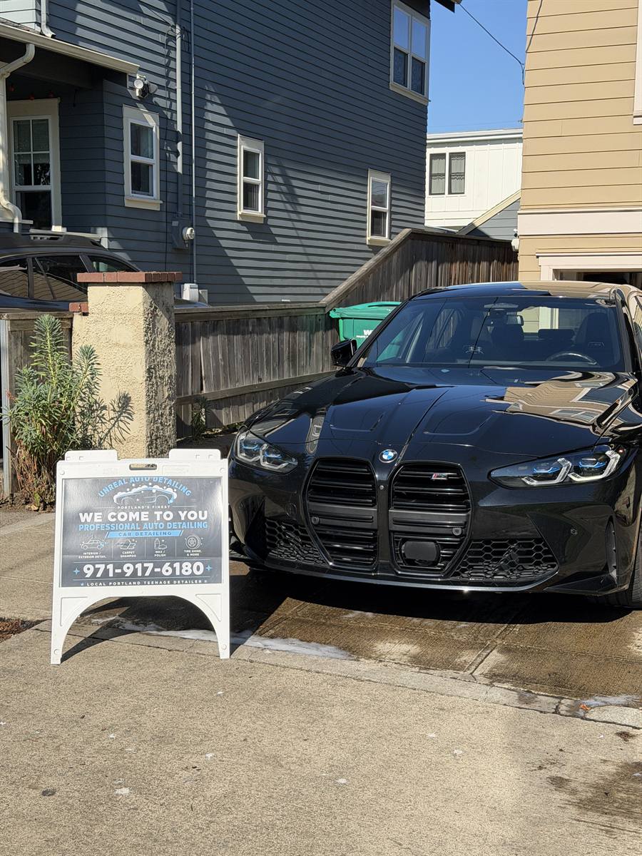 BMW M3 on site with the Unreal Auto Detailing sign