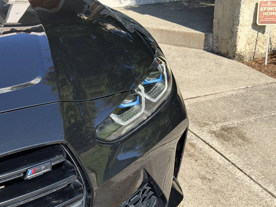 BMW M3 headlight and paint detail close up